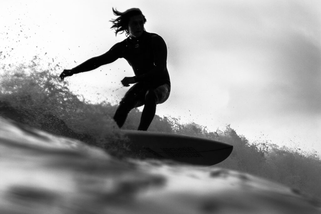 A man surfing shows an example of a flow state. 